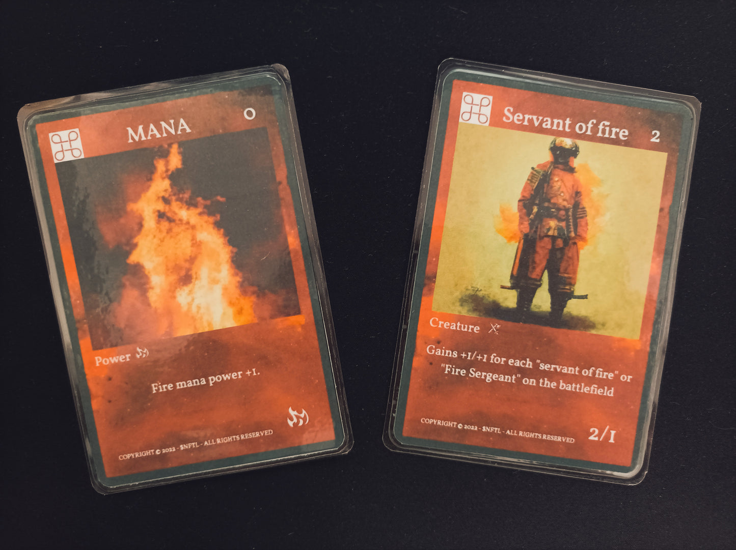 $NFTL Game cards : 1 Common CARD Servant of fire and 1 Common CARD FIRE MANA #1
