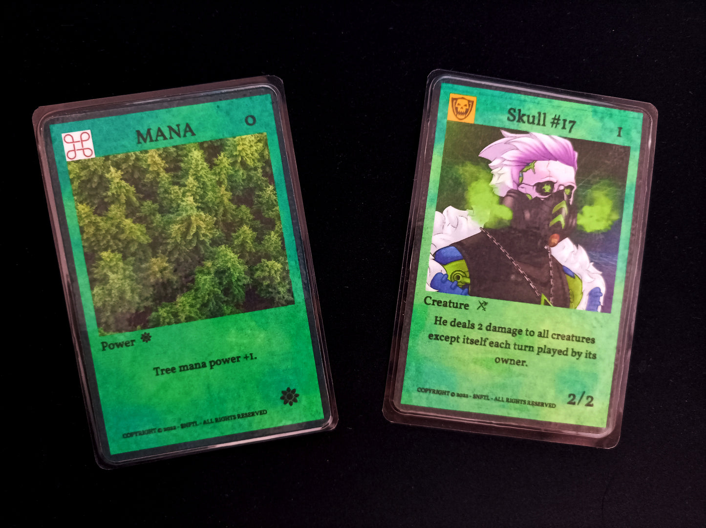 $NFTL Game cards : 1 rare SKULL #17 and 1 common TREE MANA#1